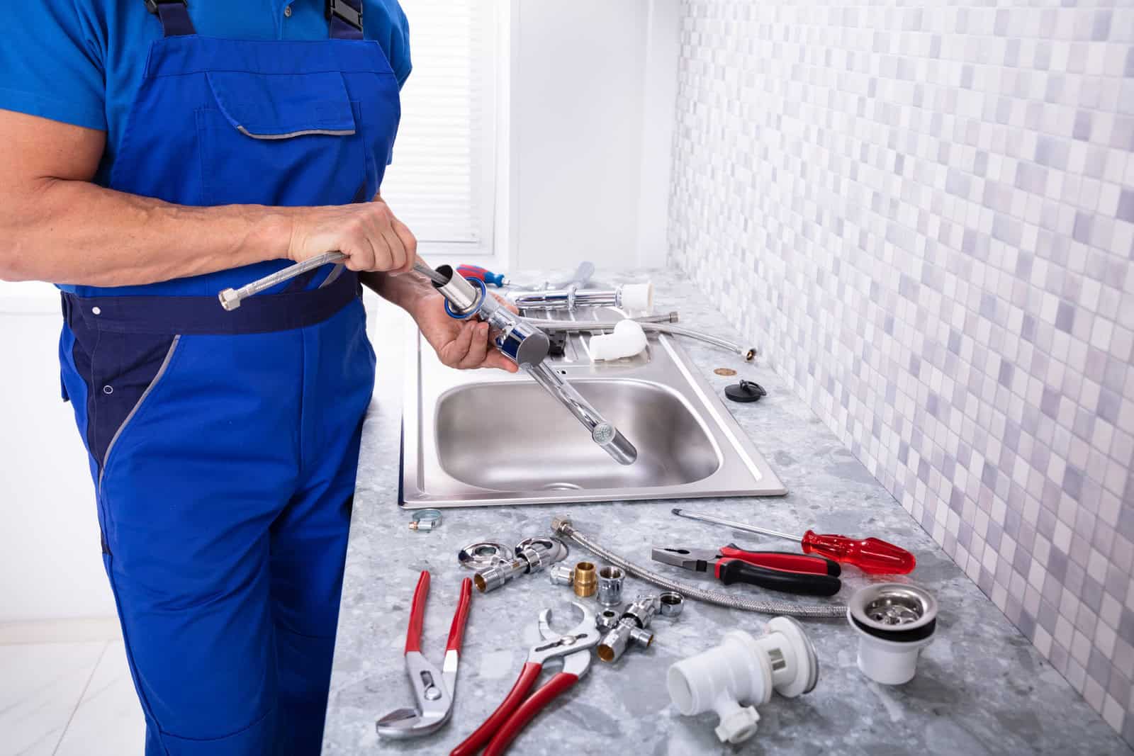 Worker Fixing Water Tap plumbing repair, plumbing services, plumbing replacement