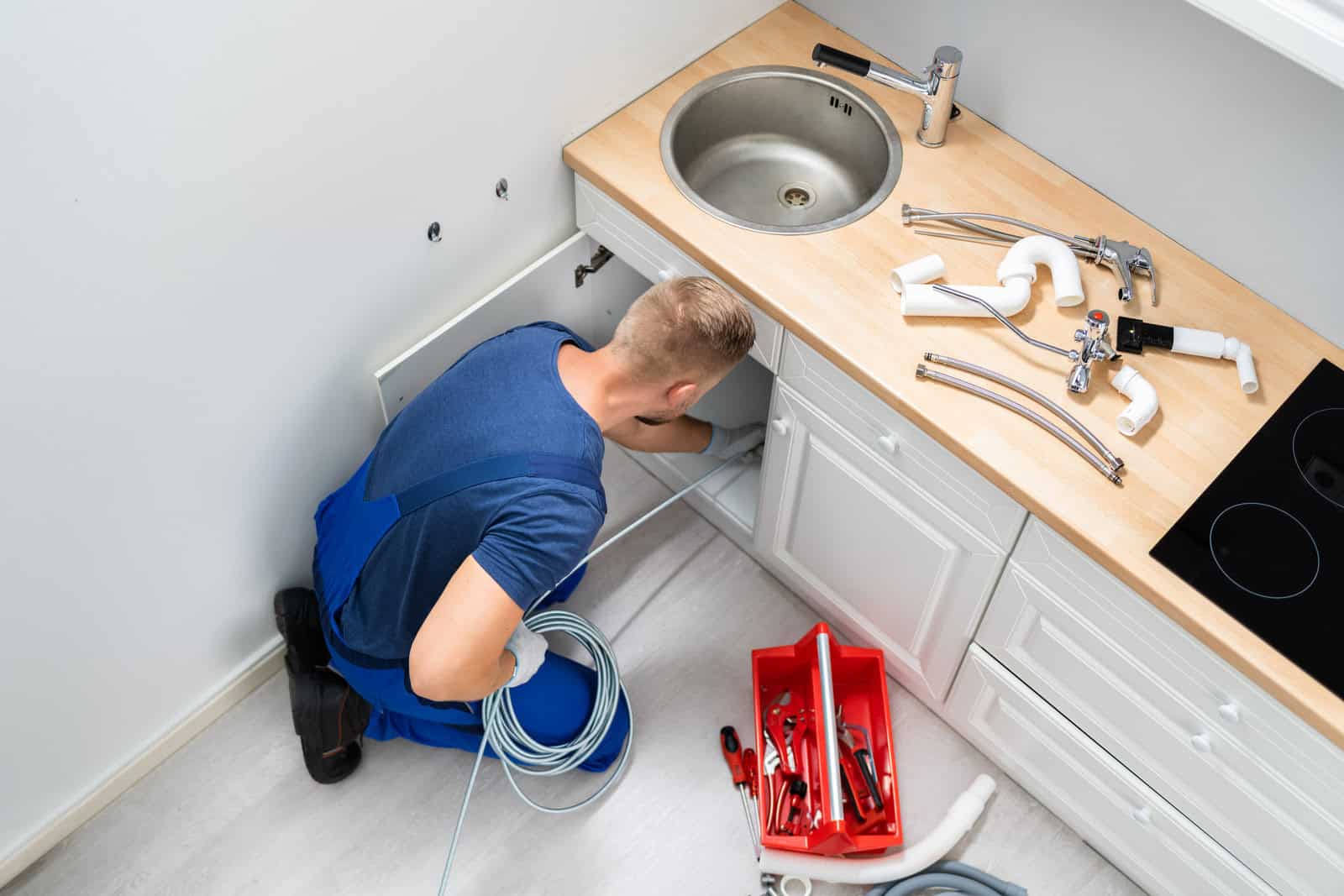 Plumber Cleaning Clogged Sink Pipe commercial plumbing in oxford al,